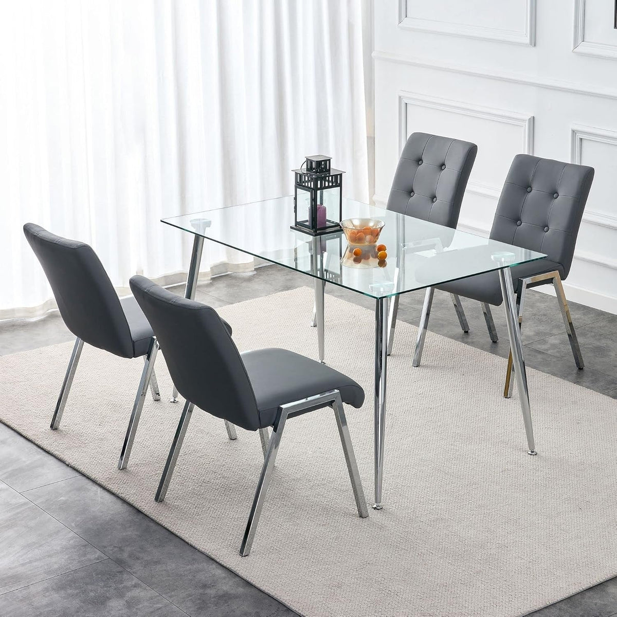 Dark tufted chairs and a lantern centrepiece around the table in a pale panelled dining room