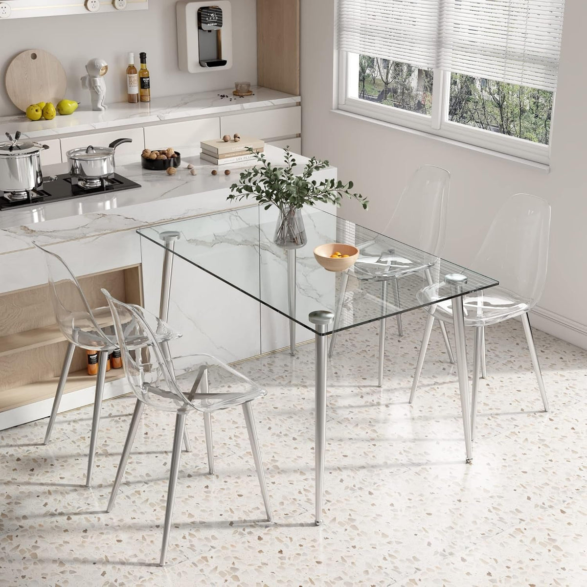 Clear acrylic chairs set around the table in a marble and terrazzo kitchen