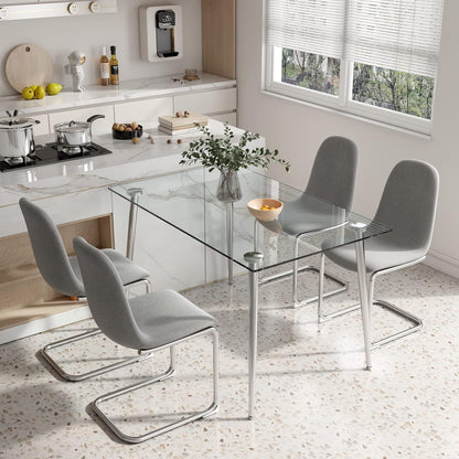 Grey chairs at the table in a kitchen with a stone backsplash and open shelving