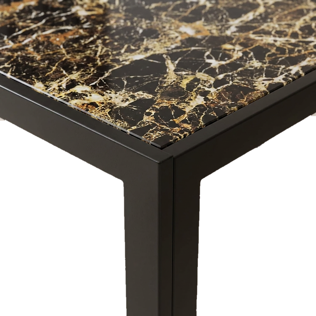 Close-up of tempered glass tabletop corner with marble print over a black metal frame