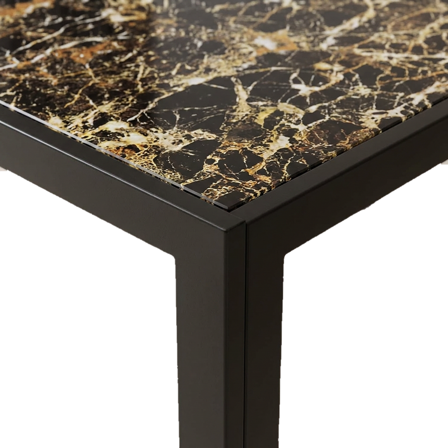 Close-up of tempered glass tabletop corner with marble print over a black metal frame