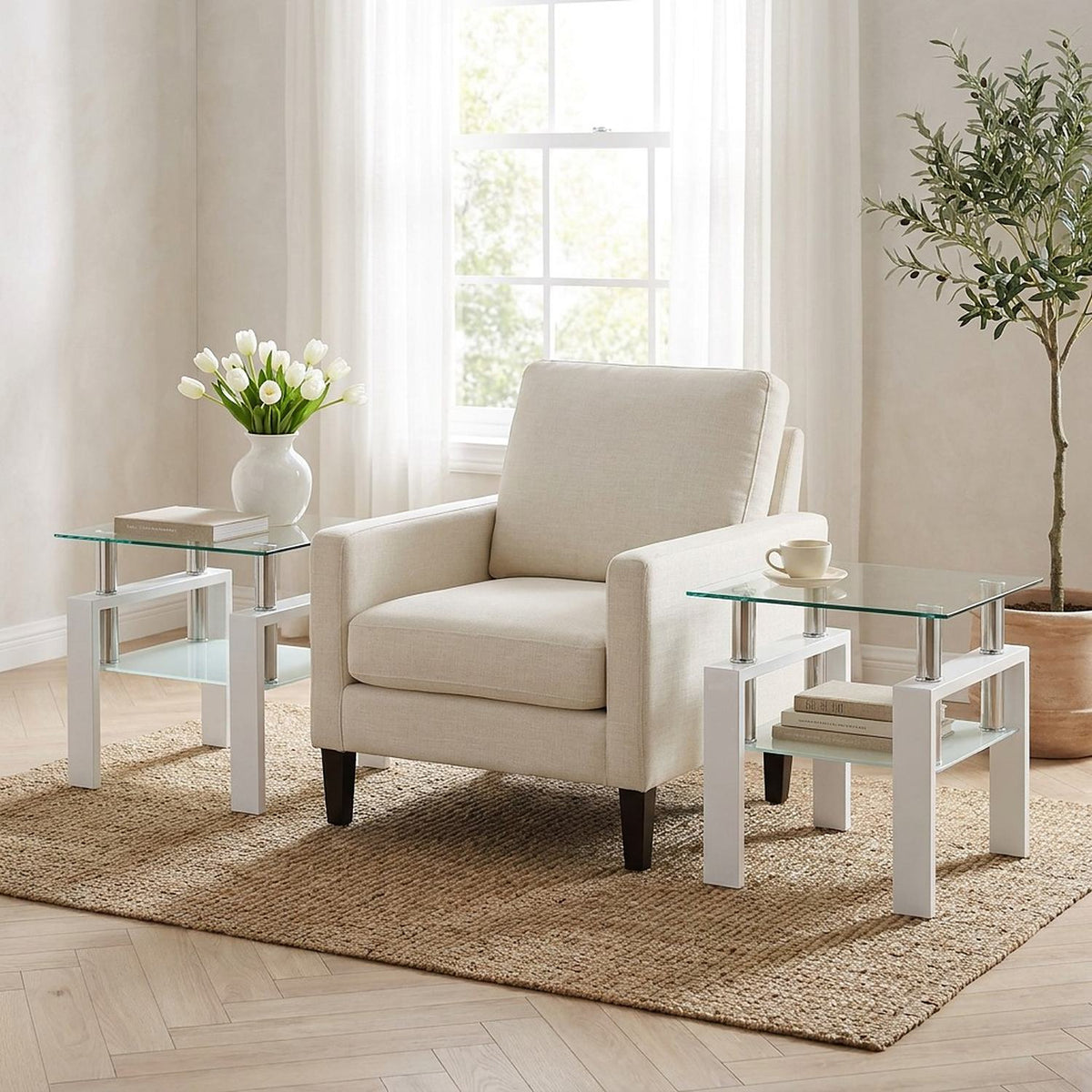 Pair of white-frame glass end tables on either side of a cream armchair in a bright living room
