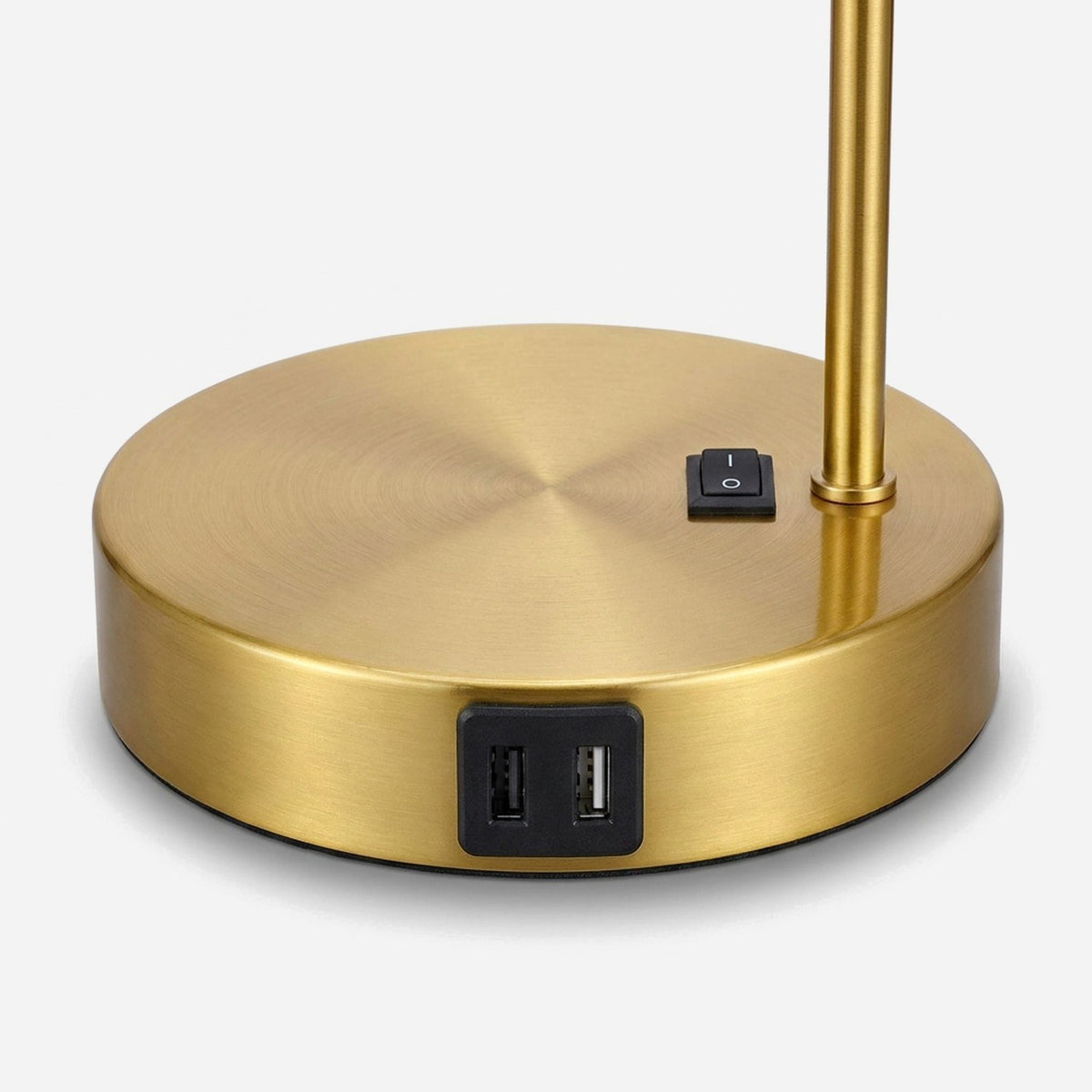 Brushed brass base with two USB ports and the switch beside the stem (close-up detail)