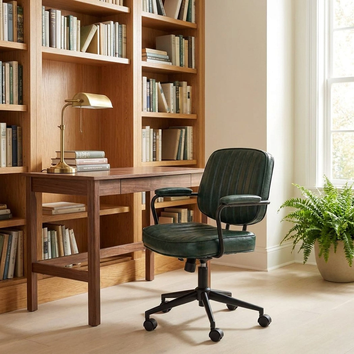 Green leather office chair at a wooden desk in a home library