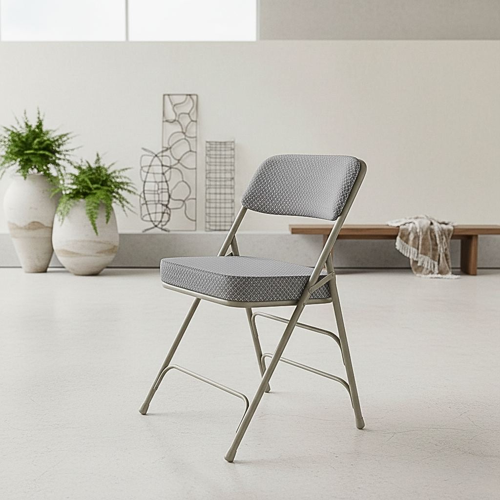 2-pack of Hercules series folding chairs with gray fabric cushioned seats and heavy-duty steel frames, ideal for high-capacity event seating.