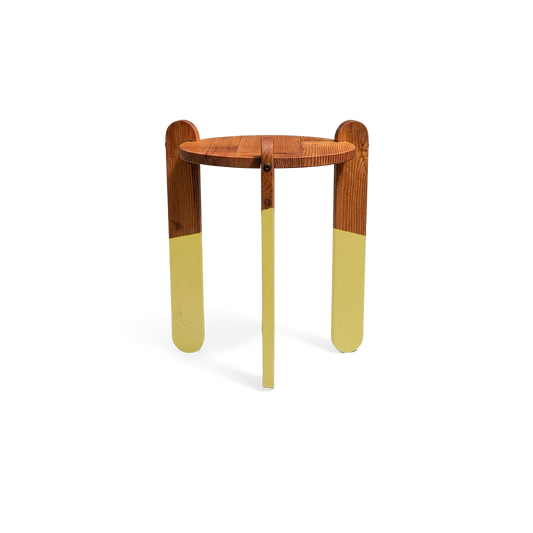 Modern intersecting-leg side table on a #f3f3f3 studio background (plain studio)