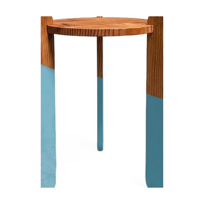 Center crossing leg and color-dip finish detail on the side table