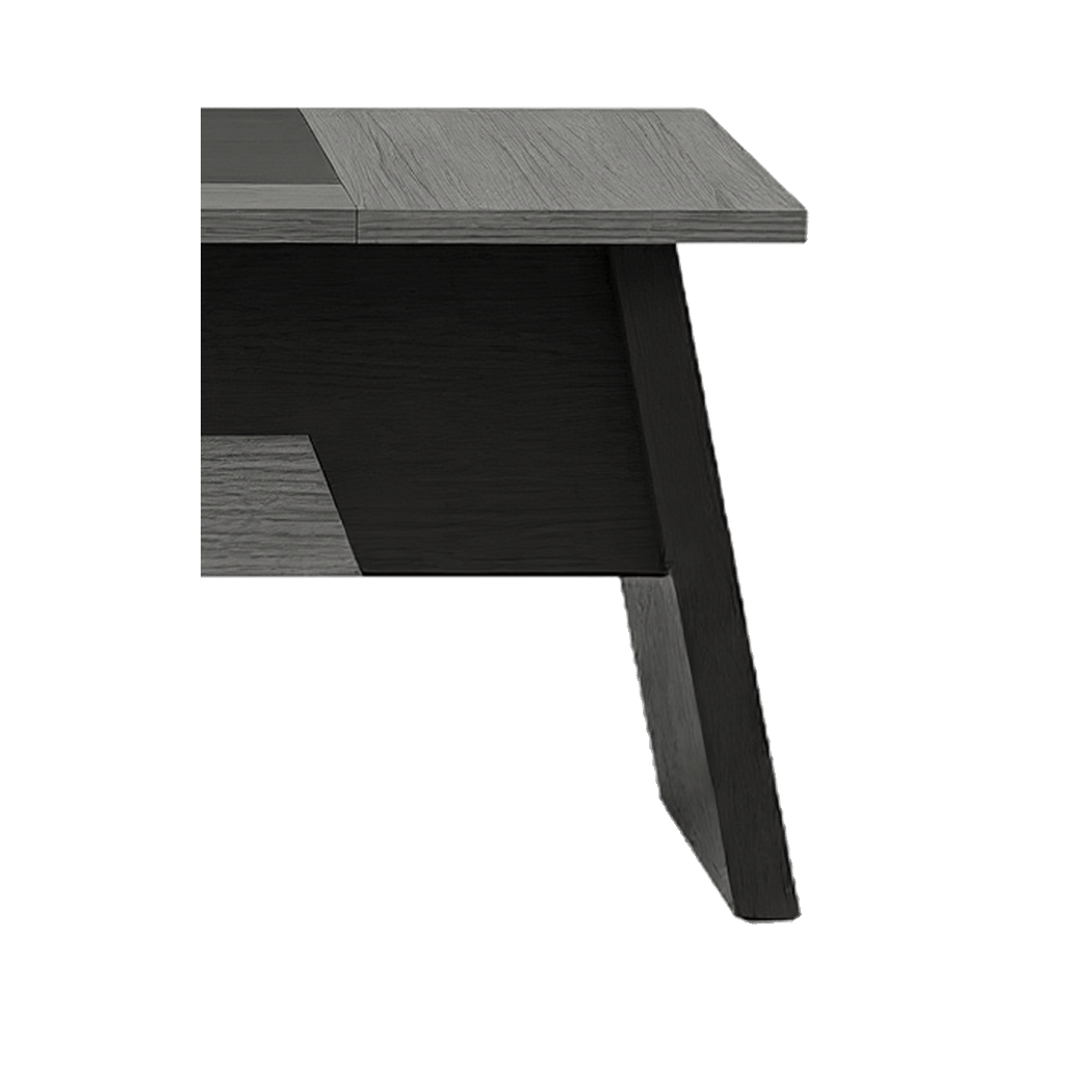 Sled leg close-up of the grey L-shaped desk, black angled frame under a woodgrain top