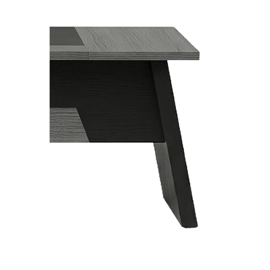 Sled leg close-up of the grey L-shaped desk, black angled frame under a woodgrain top