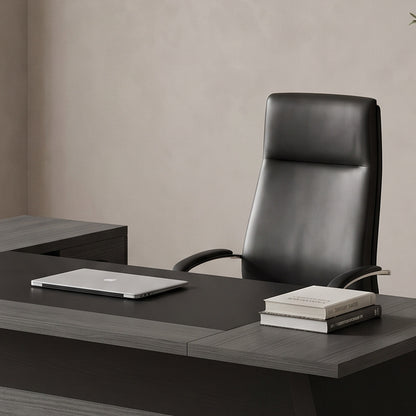 Close-up of the desk work surface with a laptop and books by a sheer-curtained window