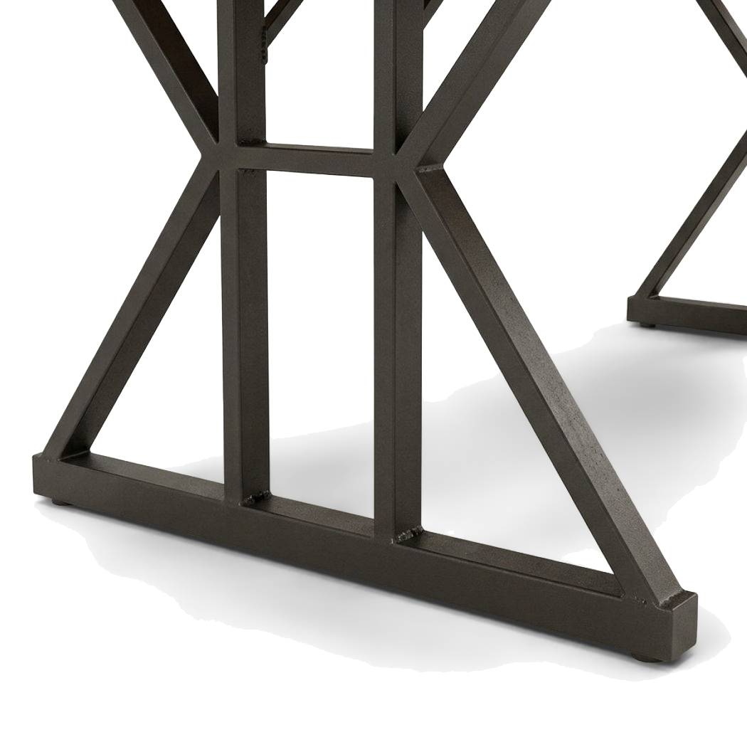 Close-up of the black trestle base, its welded braces meeting the flat foot bar (close-up detail)