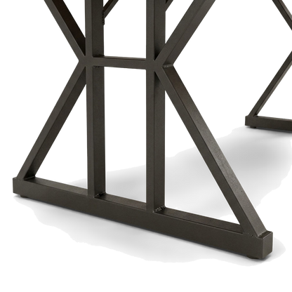 Close-up of the black trestle base, its welded braces meeting the flat foot bar (close-up detail)