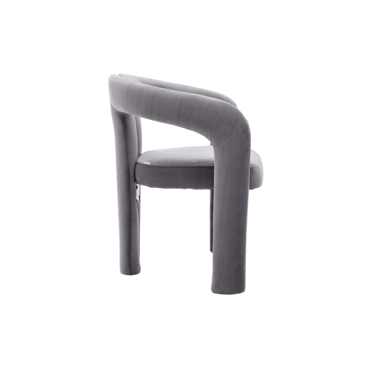 Velvet dining armchair with curved back and plush grey upholstery.