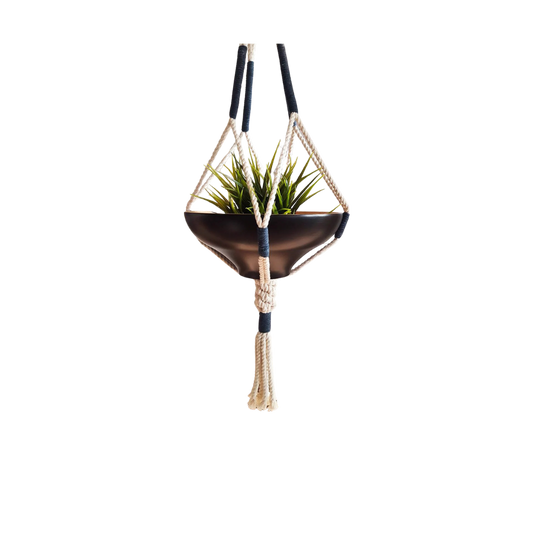 Handcrafted macrame plant hanger with navy wraps suspending a dark bowl planter, front view (plain studio)