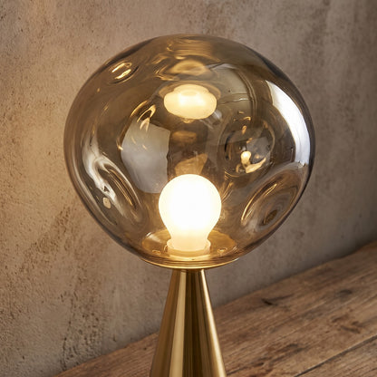 Melt table lamp — frosted globe texture close-up in ambient room setting (close-up detail)