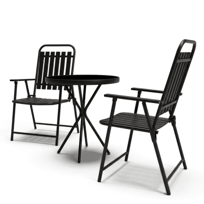 Metal folding bistro set at an angle, black frame and tempered glass top on #f3f3f3 studio background (plain studio)