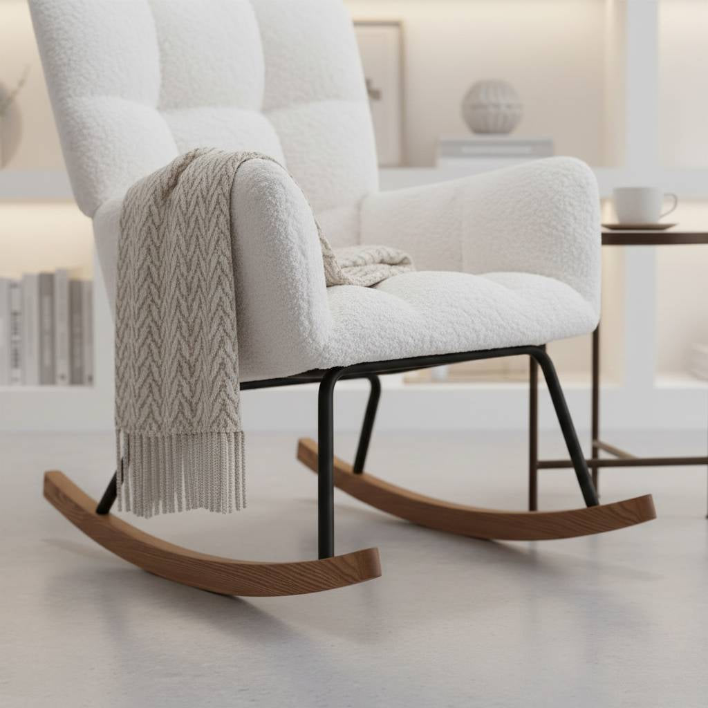 Modern white bouclé rocking chair with a tall backrest, styled in a bright indoor garden setting with large black-frame windows.