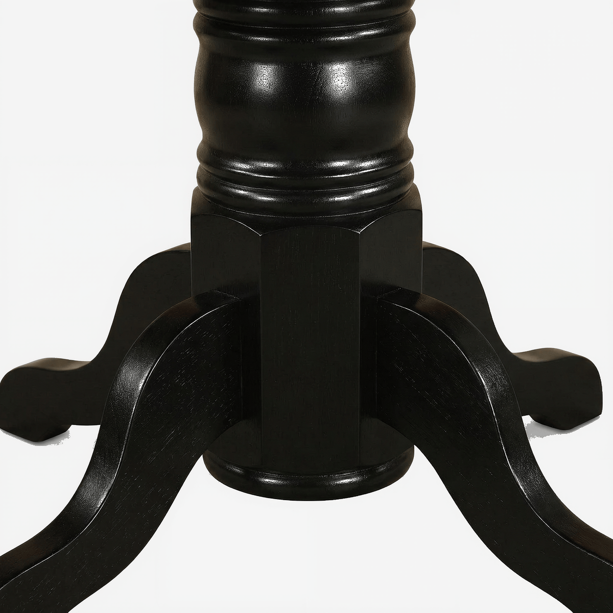 Black turned pedestal column and sabre feet of the kitchen table on a light grey ground (close-up detail)