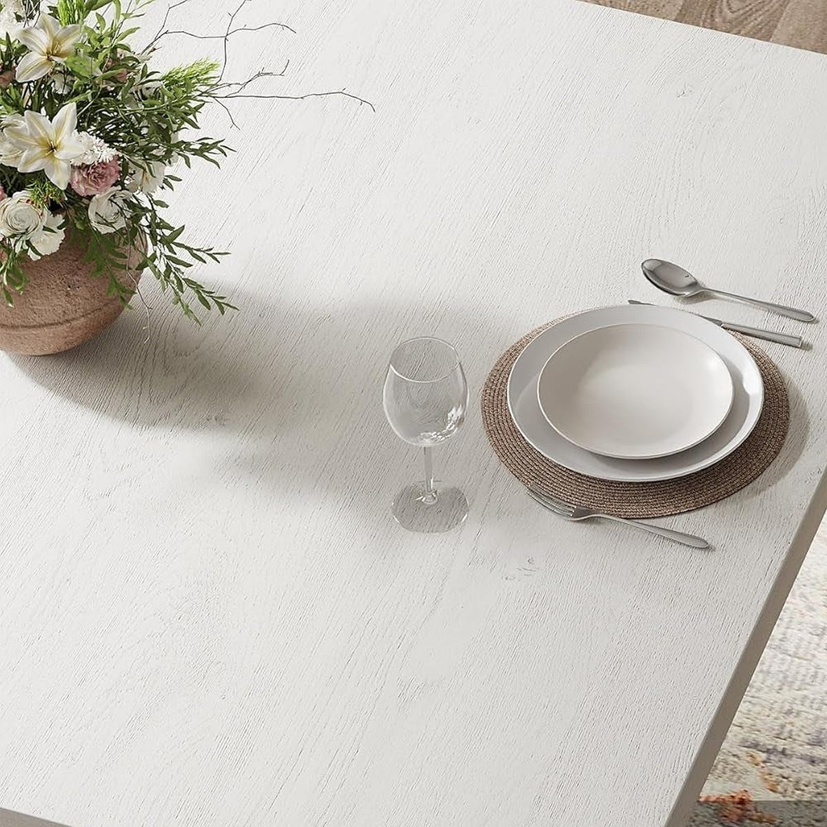 Thick white top edge of the pedestal dining table (close-up detail)
