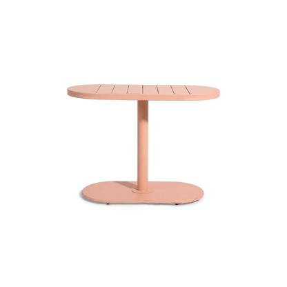 Pink oval slatted table on a single column and oval foot, front view (plain studio)