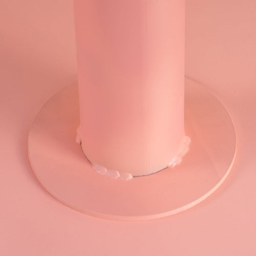 Weld collar at the base of the pink table column (close-up detail)
