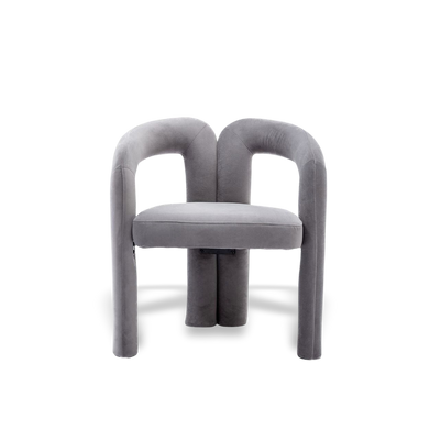 Velvet dining armchair with curved back and plush velvet upholstery.