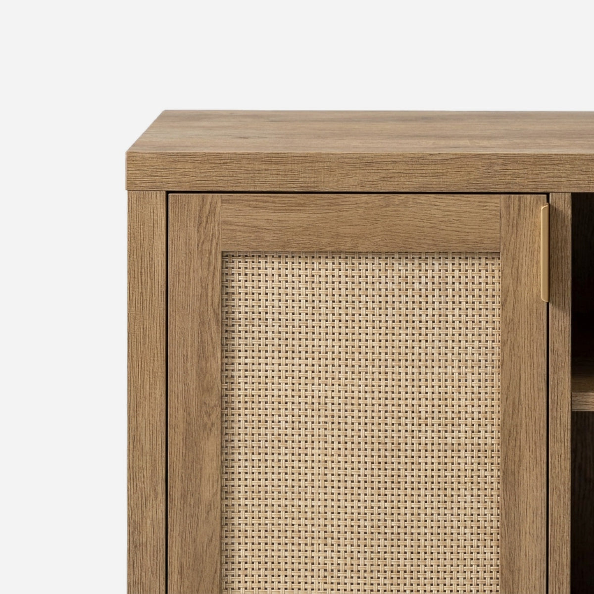 Woven rattan-weave door panel and brass-tone pull on an oak door (close-up detail)