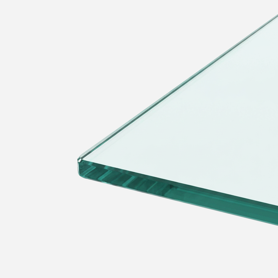 Glass tabletop edge on the rectangular coffee table, clear and smooth against the black frame
