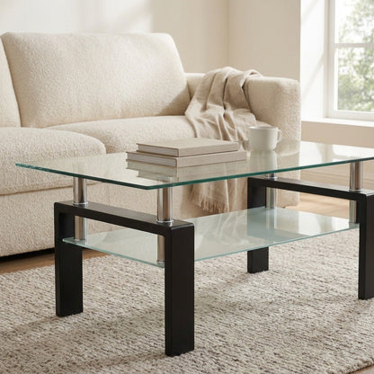 Two-tier black glass coffee table in a bright living room beside an armchair