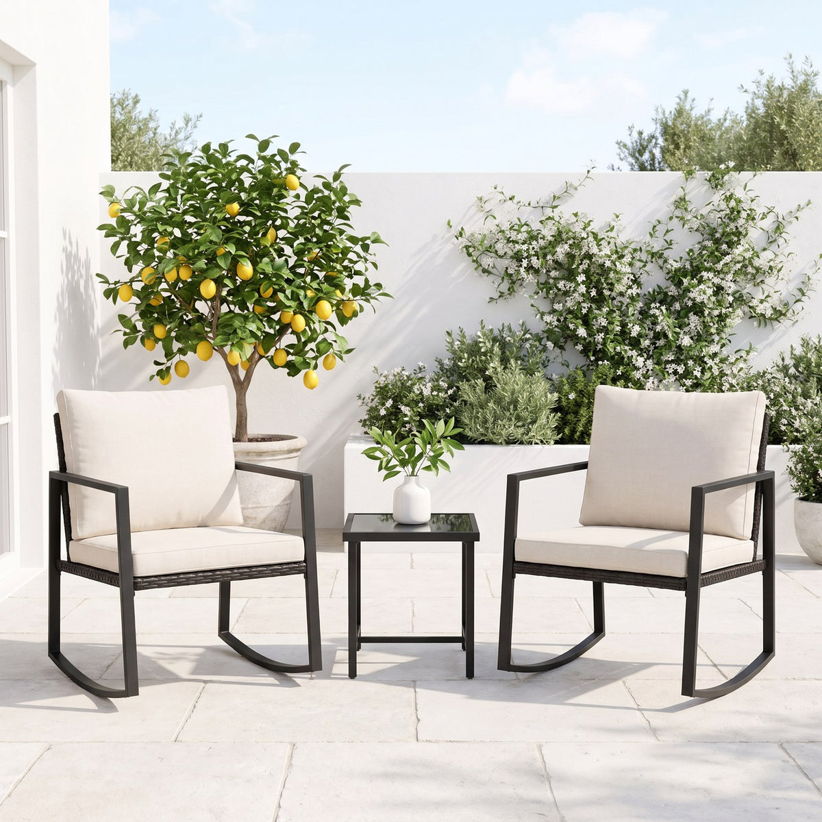 Black rocking chairs and a glass-top side table on a courtyard terrace
