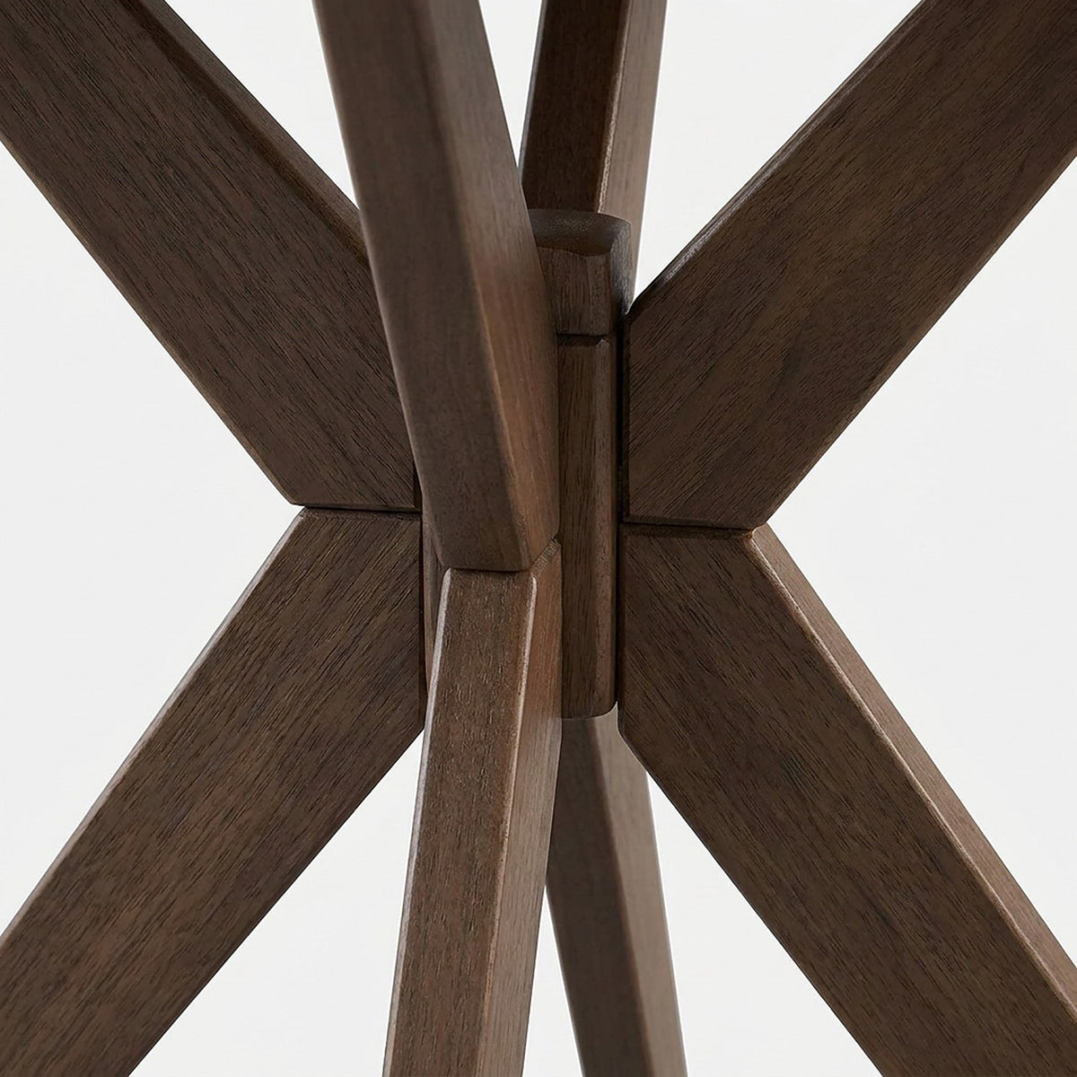 Close-up of the cross-shaped walnut rubber wood leg joint under the table