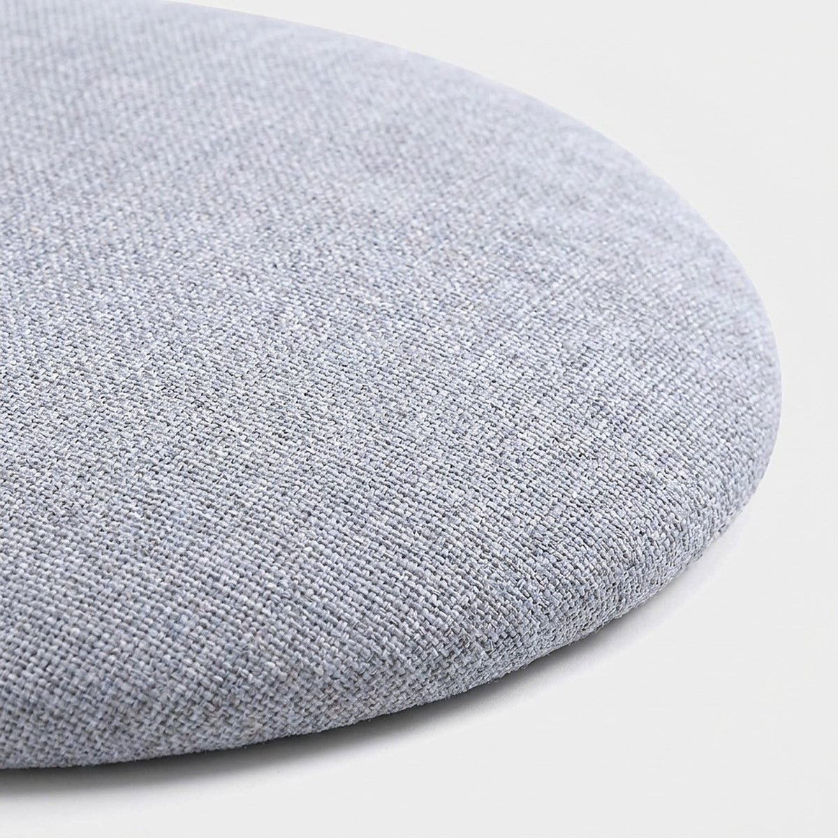 Close-up of the round light grey padded seat cushion in woven fabric