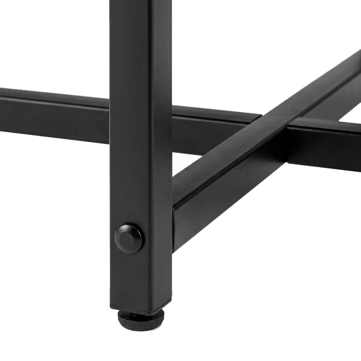 Black metal leg joined to the crossed brace with a round bolt and an adjustable floor foot on a round lift-top coffee table (close-up detail)