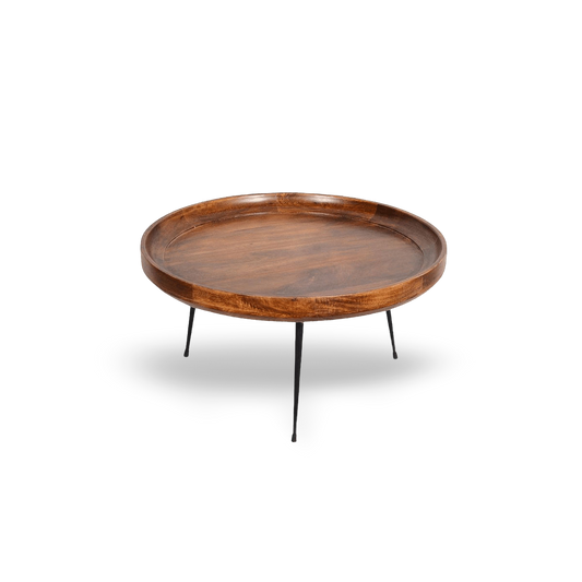 Natural brown round mango wood coffee table with splayed black metal legs on a clean #f3f3f3 background.