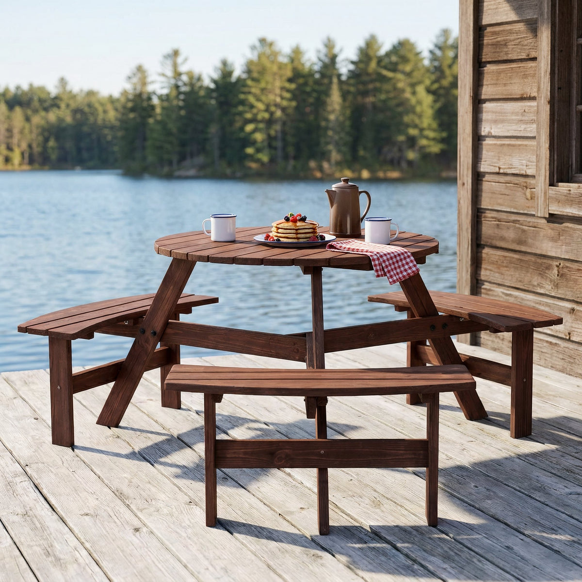 Fir wood circular picnic set with benches on a lakeside timber deck beside a cabin, set for pancakes and coffee