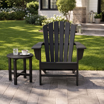 A matching round side table with a glass of water and a cup of coffee, set against a lush green backyard lawn.