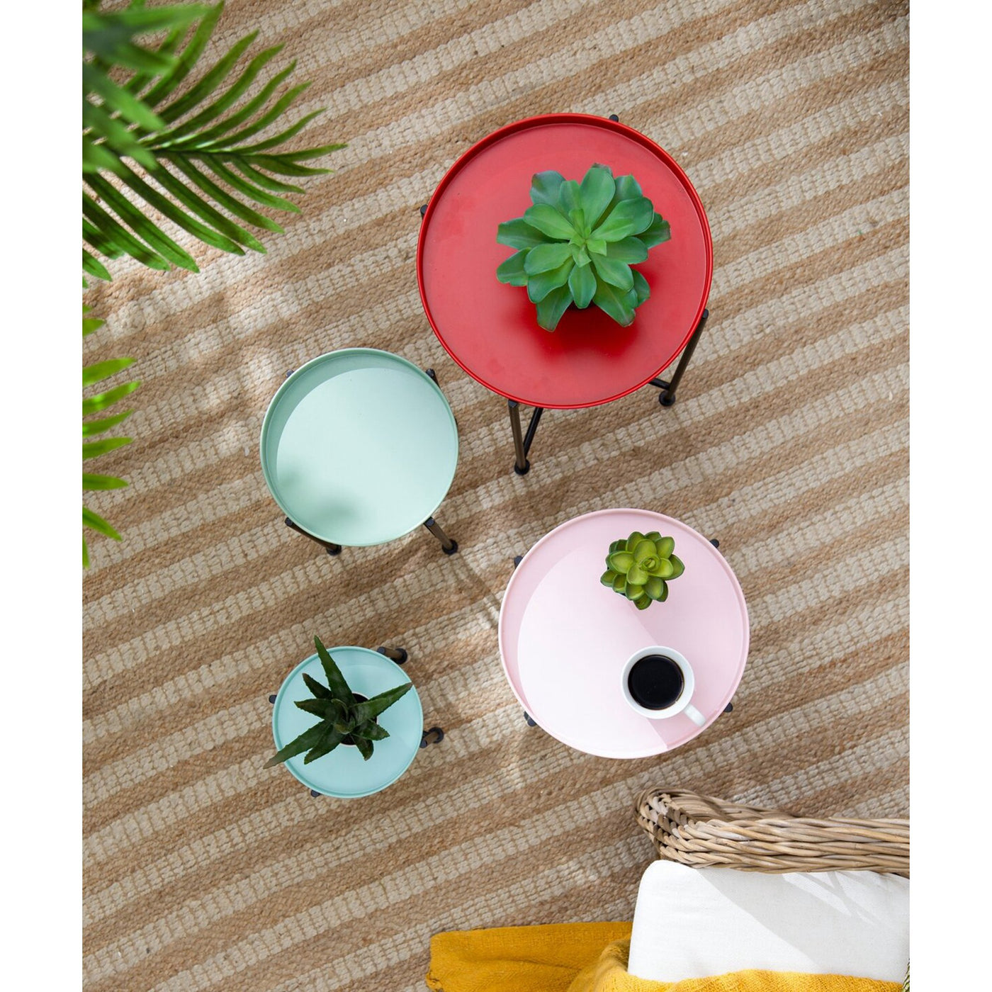 round tables with planters on a striped surface