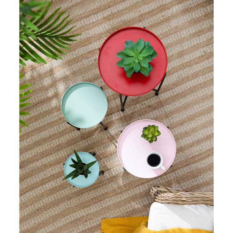 round tables with planters on a striped surface