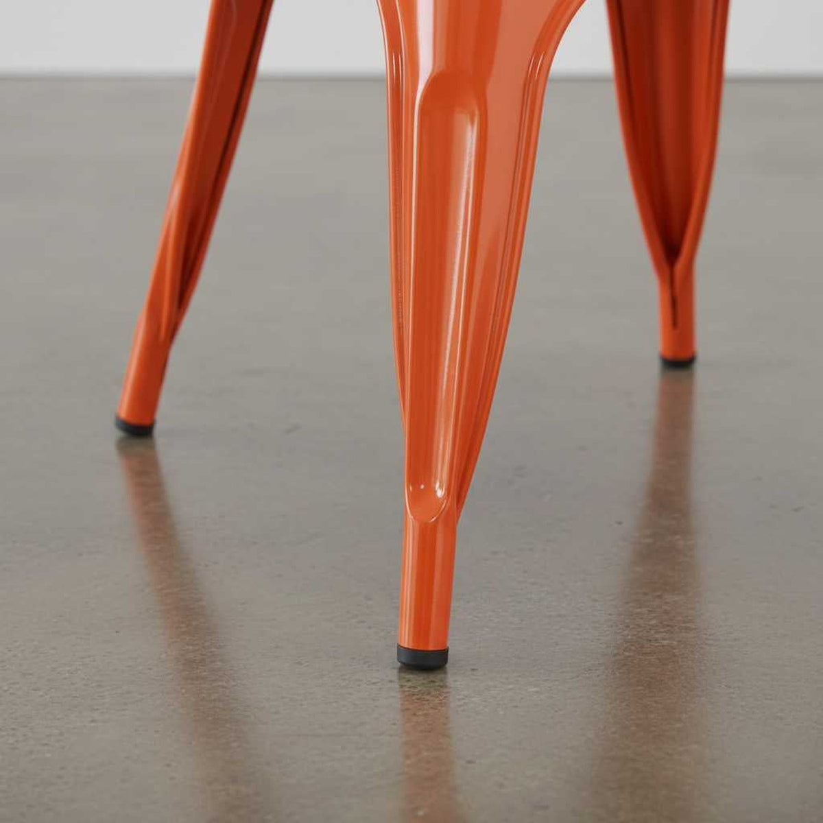 Vibrant rust metal dining chair legs with stackable design for small spaces (close-up detail)