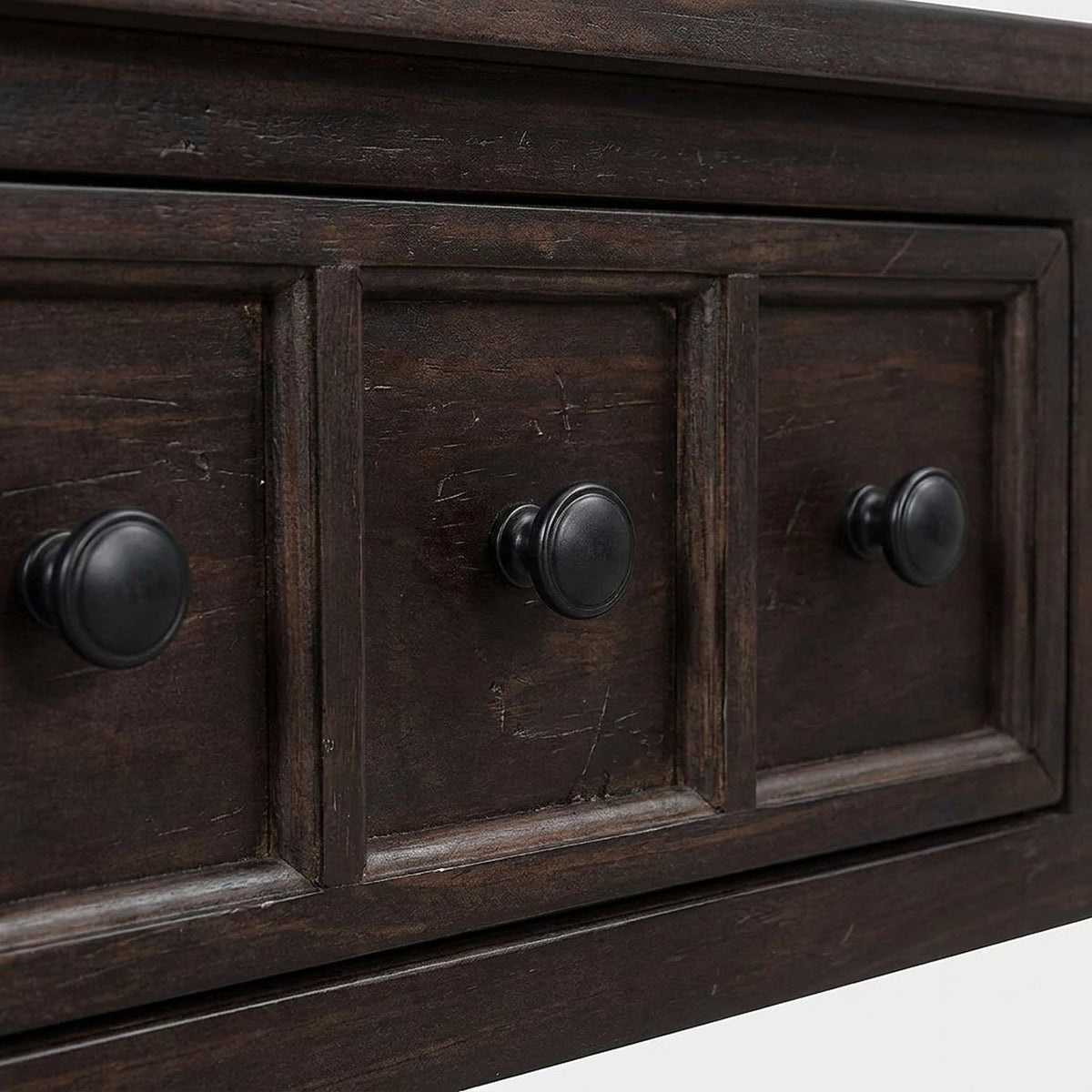 Framed drawer front with round black knobs (close-up detail)