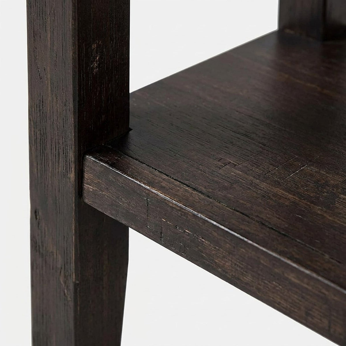 Square solid leg meeting the lower shelf (close-up detail)