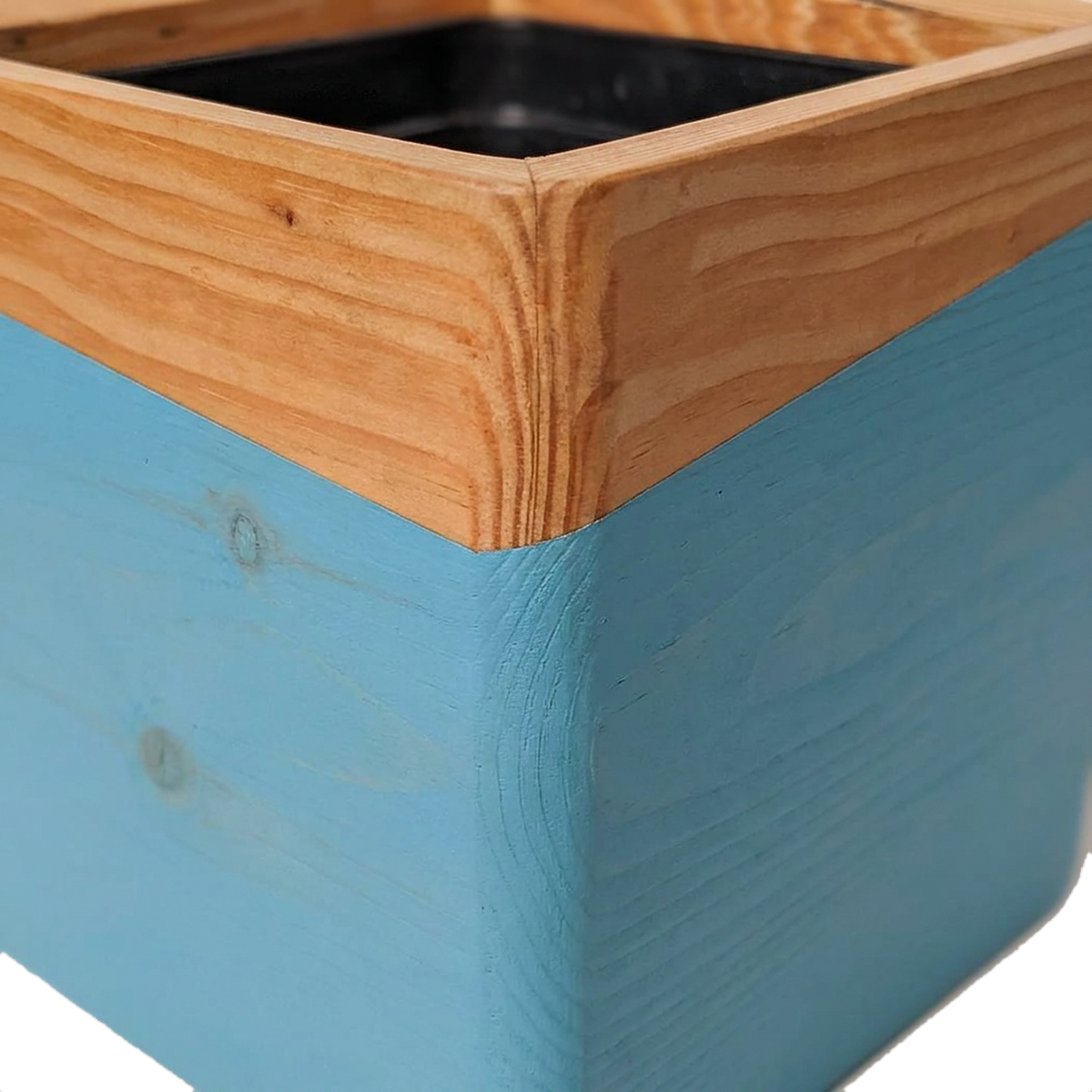 Dipped blue band meeting the natural pine on the wooden wall planter (close-up detail)