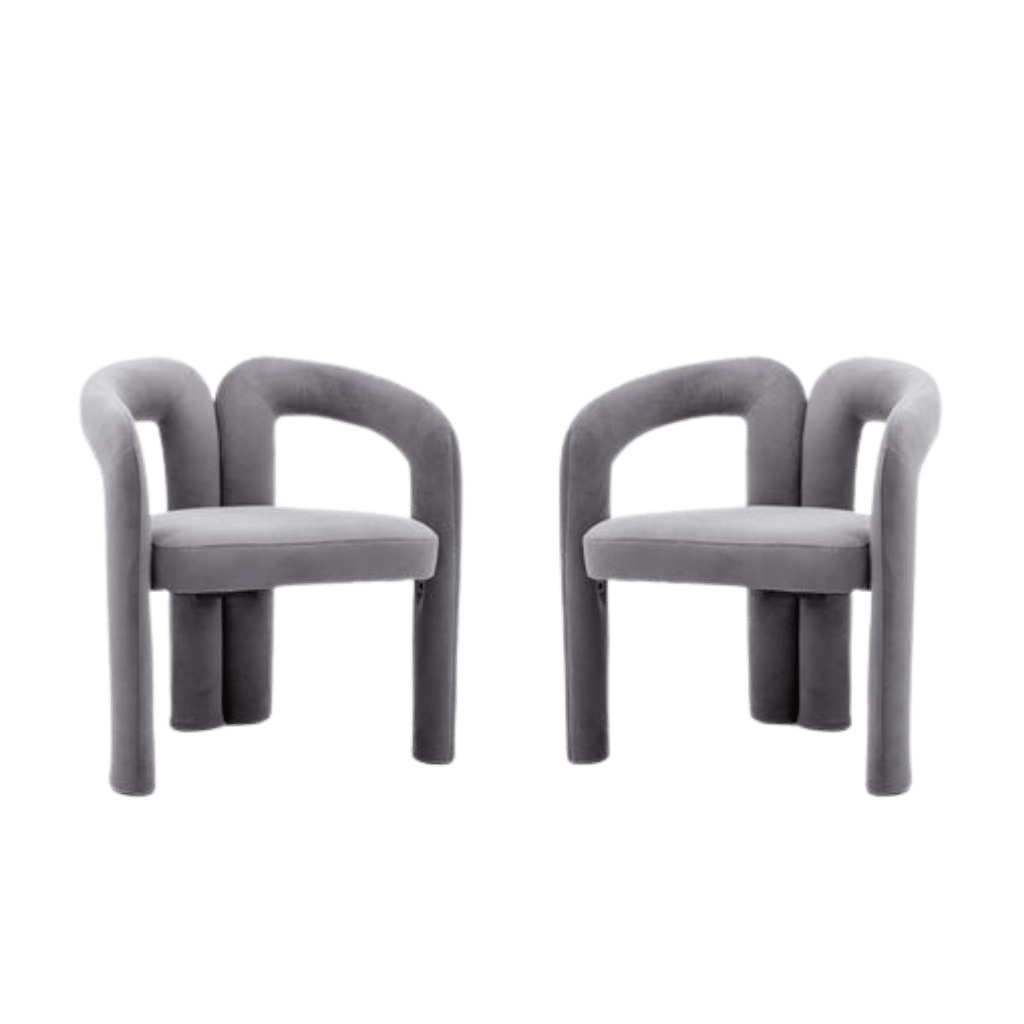 Pair of plush gray velvet dining armchairs with curved backs and cushioned seats.