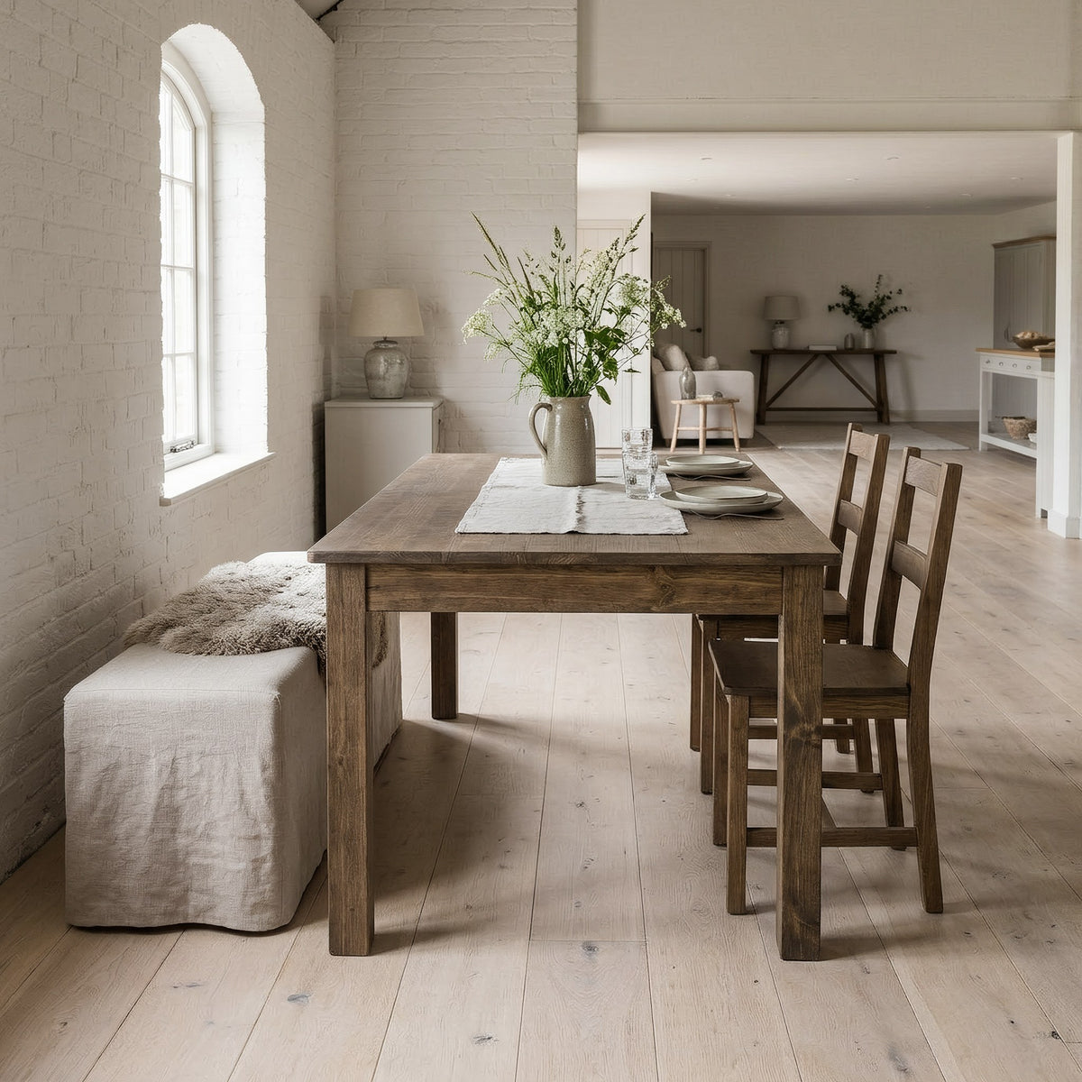 Solid pine farmhouse dining table in a bright barn dining hall