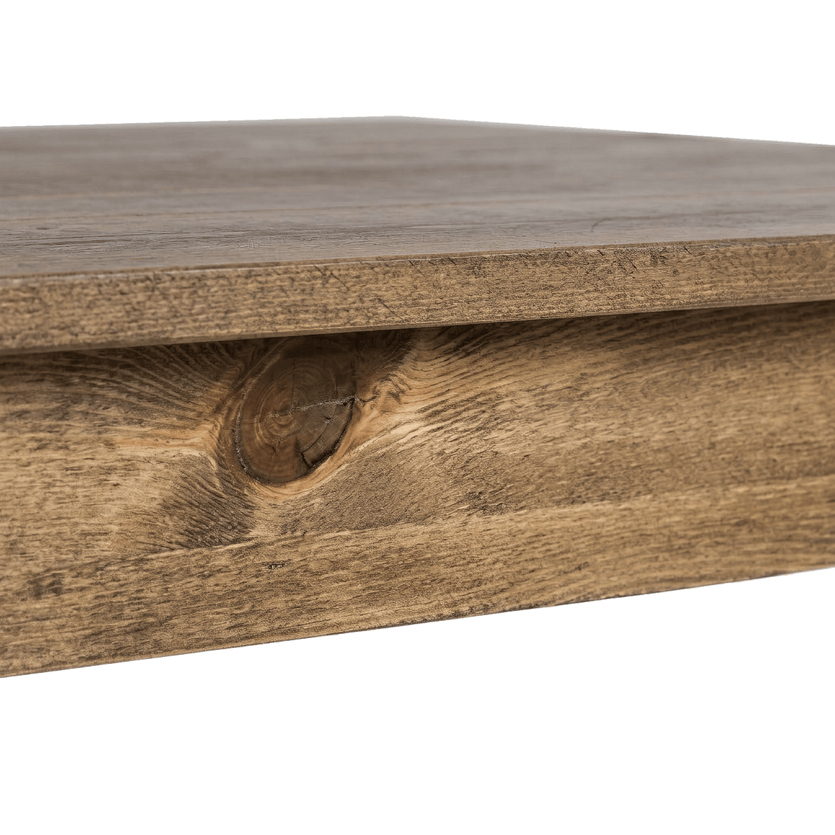 Knotty pine apron under the plank top of the farmhouse dining table (close-up detail)