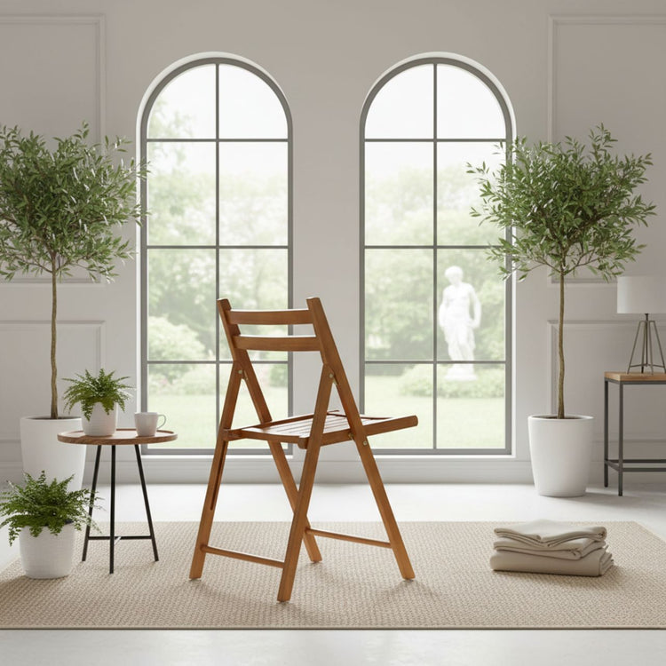 Teak folding chair set with slim, space-saving profile for indoor/outdoor use in a bright room with arched windows.