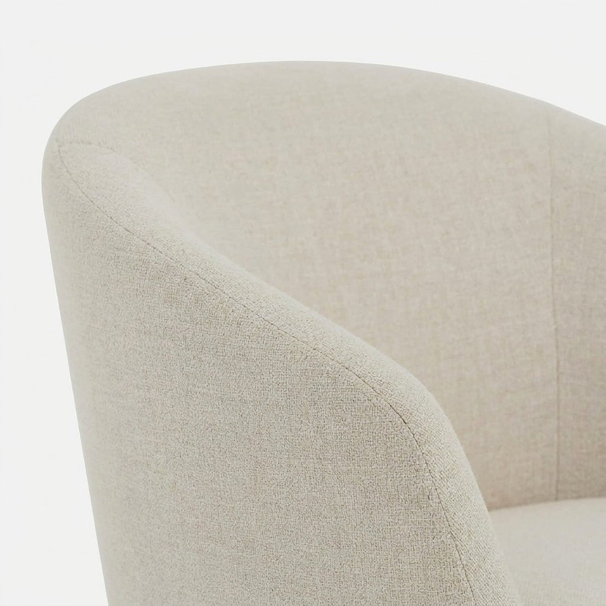 Curved wrap-around backrest of a cream upholstered chair (close-up detail)