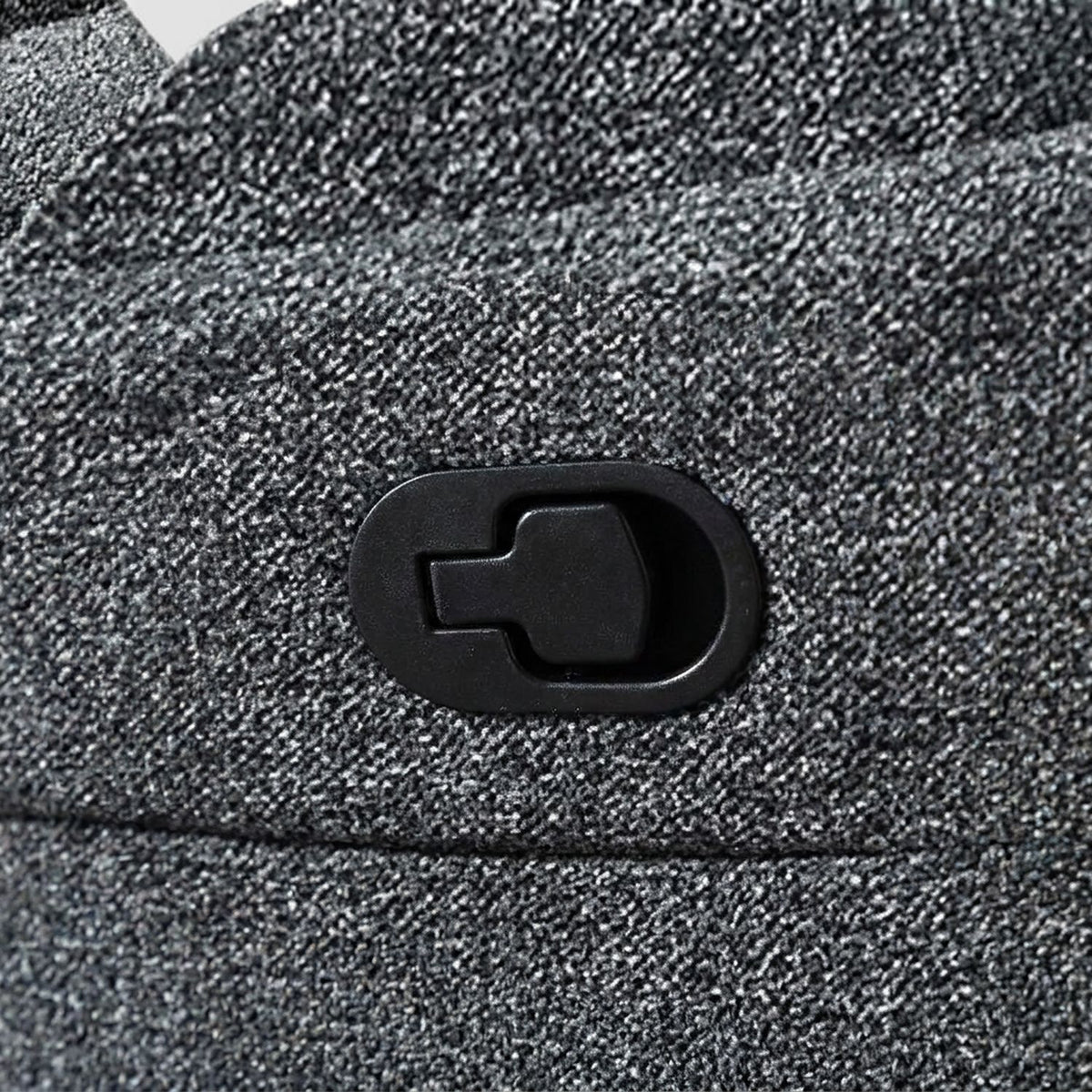 Close-up of the recline pull tab on the gray fabric armrest (close-up detail)
