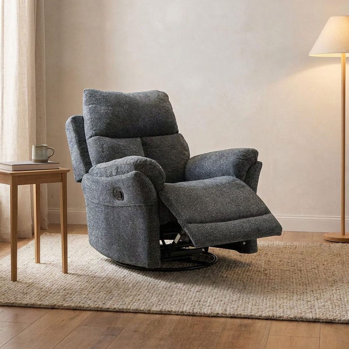 Gray swivel recliner reclined with the footrest extended in a living room, three-quarter view
