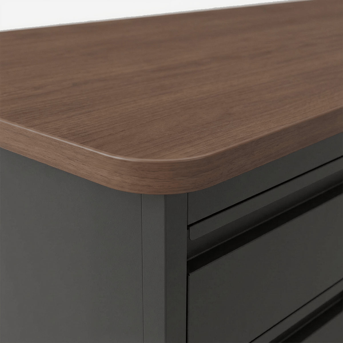 Teacher's desk walnut-finish laminate top edge on a light grey ground (close-up detail)
